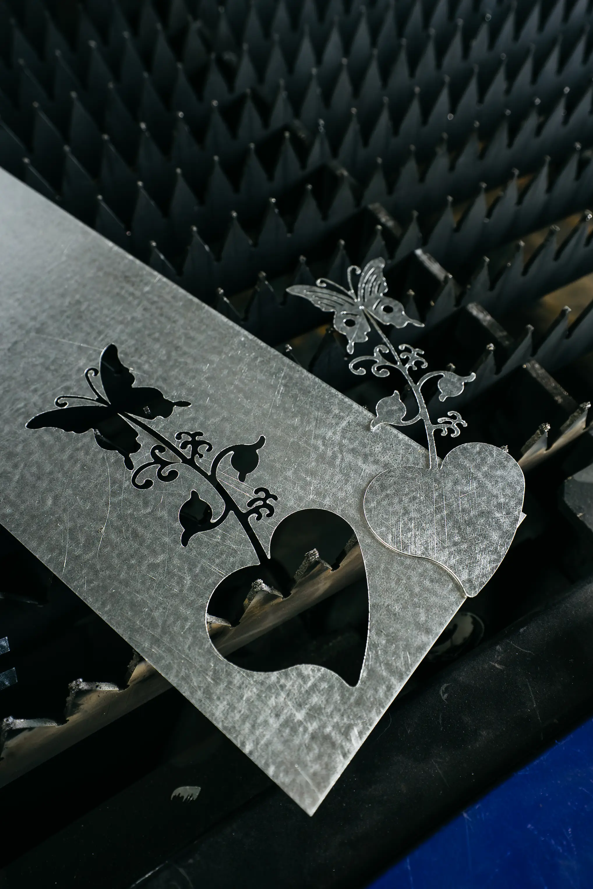Finished metal part with intricate cut detail